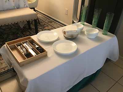 table with plates, utensils, drinking glasses