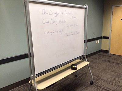 white board discussing next month's book club selection