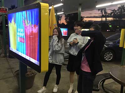 Japanese ESL students ordering food at kiosk at Sonic Drive-In