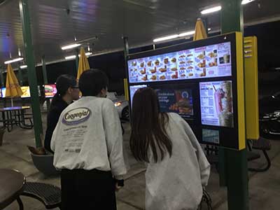 Japanese ESL students ordering food at kiosk at Sonic Drive-In