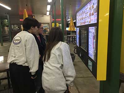 Japanese ESL students ordering food at kiosk at Sonic Drive-In