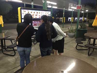 Japanese ESL students ordering food at kiosk at Sonic Drive-In