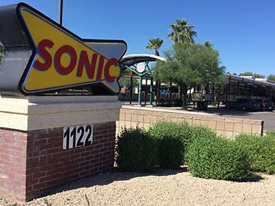 sign and exterior seen from entrance at Sonic Drive-In