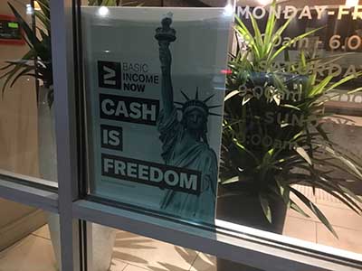 Cash is Freedom sign in window at Emerson apartment building