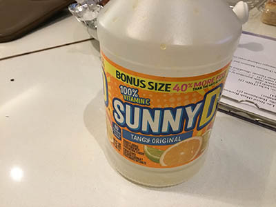 empty container of Sunny Delight orange drink