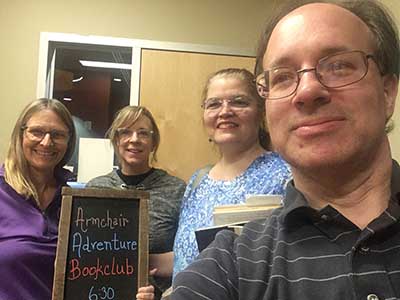 people at book club with sign