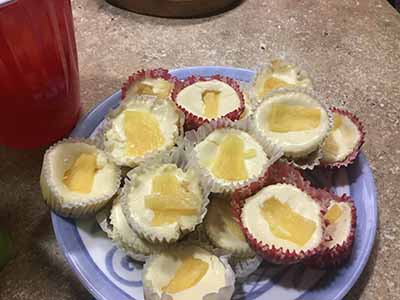mini cheesecakes topped with pineapple