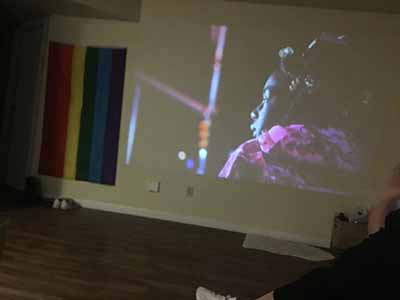 scene from film Inherent Good projected onto wall: black child