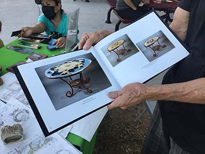 artist showing book of his art