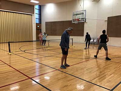 neighbors playing pickleball