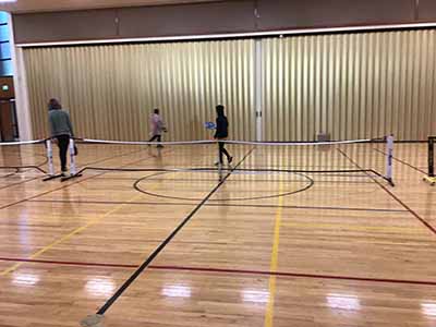 neighbors playing pickleball