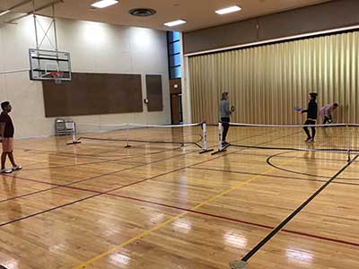 neighbors playing pickleball