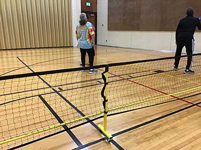 neighbors playing pickleball