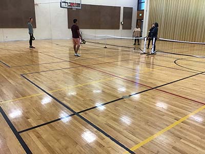 neighbors playing pickleball