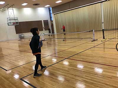 neighbors playing pickleball