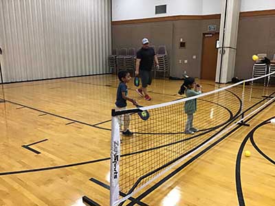 neighbors playing pickleball