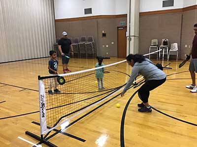 neighbors playing pickleball