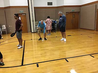 neighbors playing pickleball