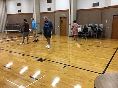 neighbors playing pickleball