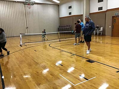 neighbors playing pickleball