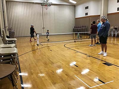 neighbors playing pickleball