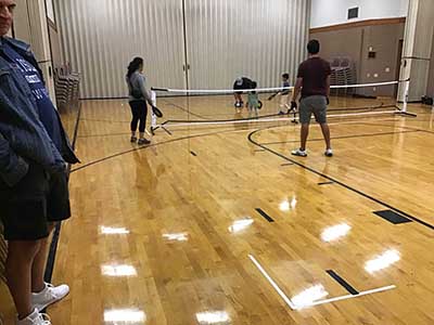 neighbors playing pickleball