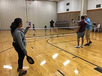 neighbors playing pickleball