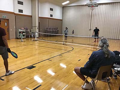 neighbors playing pickleball