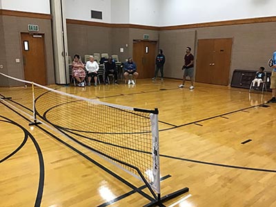 neighbors playing pickleball