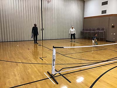 neighbors playing pickleball