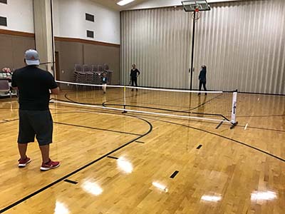 neighbors playing pickleball