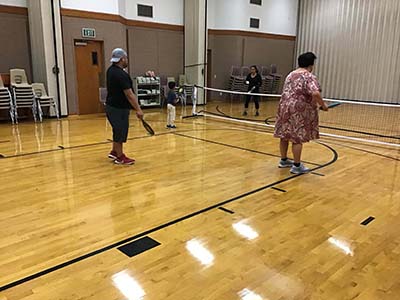 neighbors playing pickleball