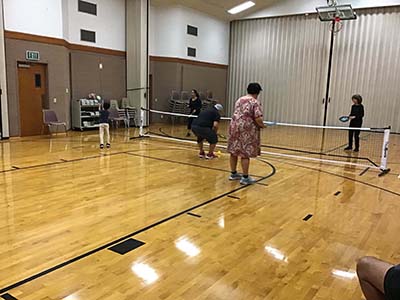 neighbors playing pickleball