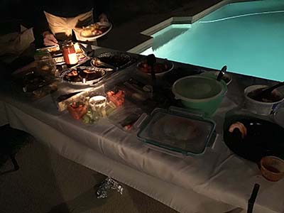 food on serving table at potluck dinner