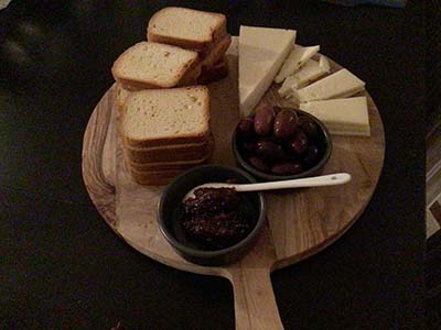 charcuterie board with bread olives cheese