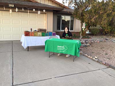 Girl Scout selling Girl Scout cookies