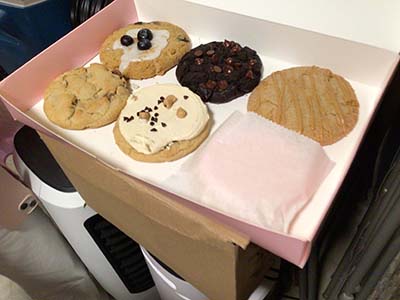 six fancy Crumbl cookies in box