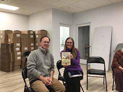 Book Club leader Tracy and neighborhood group leader Preston, holding book club at book club meeting