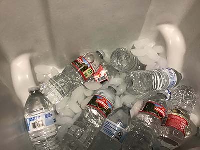 bottled water in cooler with ice
