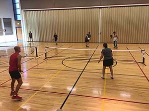 neighbors playing pickleball