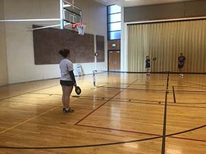 neighbors playing pickleball