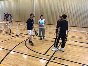 neighbors playing pickleball