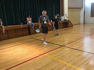 neighbors playing pickleball