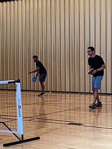 neighbors playing pickleball