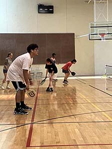 neighbors playing pickleball