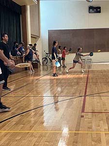 neighbors playing pickleball