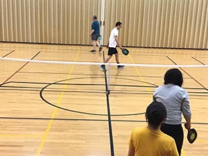 neighbors playing pickleball