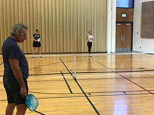 neighbors playing pickleball