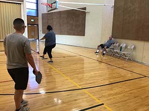 neighbors playing pickleball