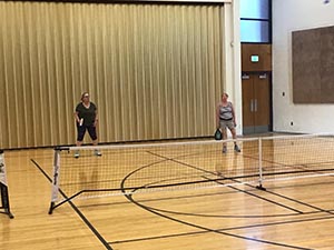 neighbors playing pickleball